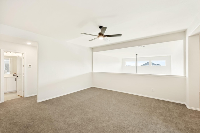 spare room with ceiling fan and carpet floors