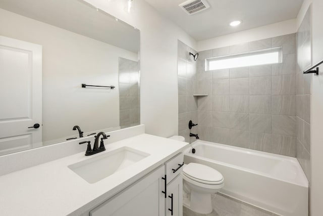 full bathroom featuring toilet, vanity, and tiled shower / bath