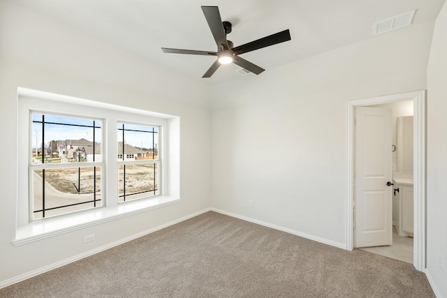 carpeted spare room with ceiling fan