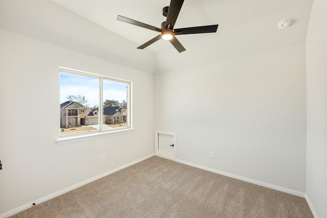 empty room with ceiling fan, lofted ceiling, and carpet flooring