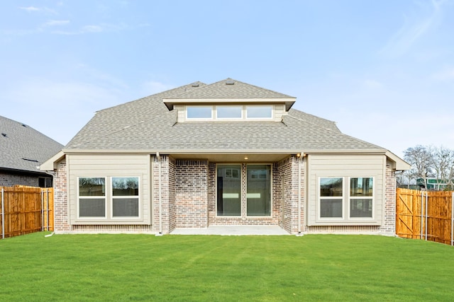 rear view of property featuring a yard