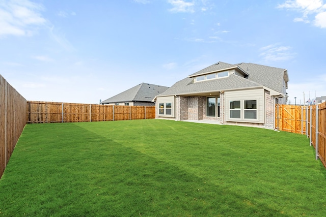 rear view of house with a yard