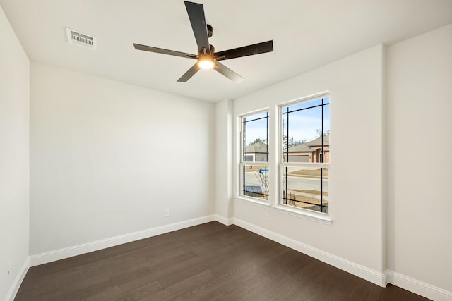 spare room with ceiling fan and dark hardwood / wood-style flooring