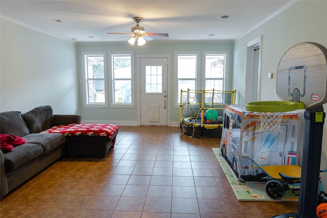 tiled living room with ornamental molding and ceiling fan