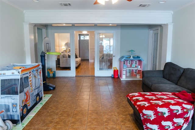 tiled living room with ceiling fan, ornamental molding, and french doors