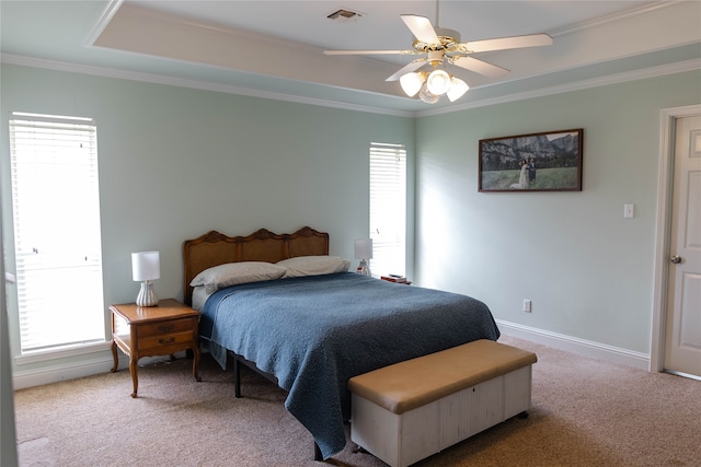 carpeted bedroom featuring crown molding and ceiling fan