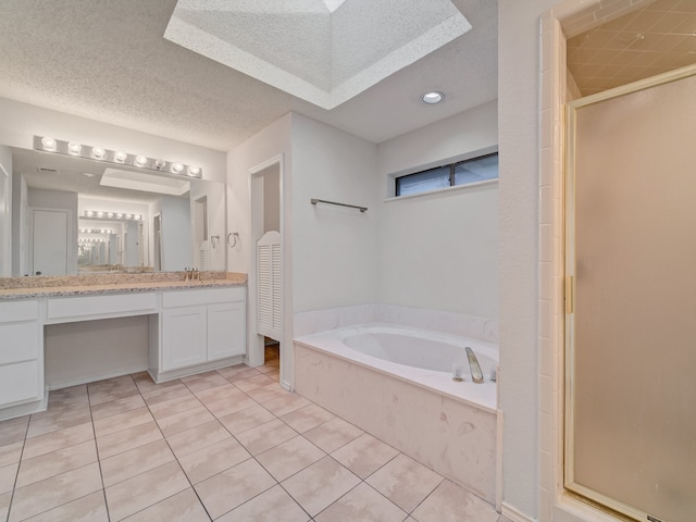 bathroom with plus walk in shower, tile patterned flooring, and vanity