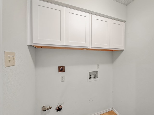 laundry area with washer hookup, cabinets, hookup for an electric dryer, and gas dryer hookup