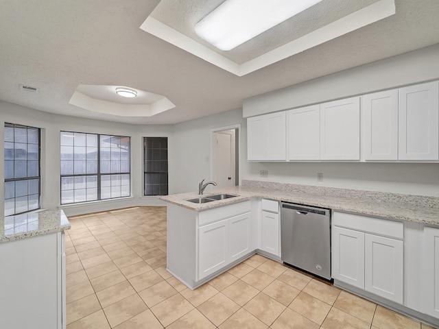 kitchen with white cabinetry, dishwasher, kitchen peninsula, sink, and a tray ceiling