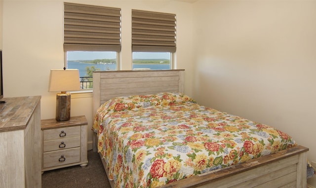 carpeted bedroom with a water view