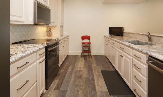 kitchen featuring sink, white cabinetry, dishwasher, light stone counters, and electric range