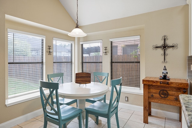 dining space with lofted ceiling and light tile patterned floors