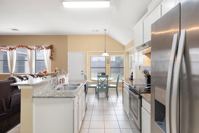 kitchen featuring appliances with stainless steel finishes, hanging light fixtures, white cabinets, lofted ceiling, and sink