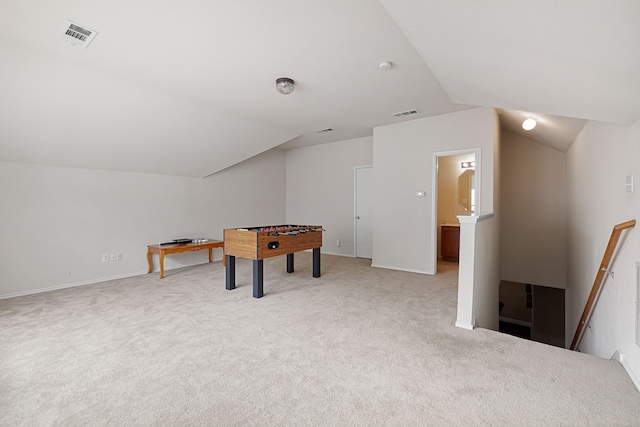 playroom with lofted ceiling and light colored carpet