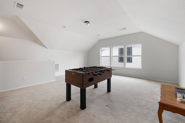 rec room with lofted ceiling and light carpet