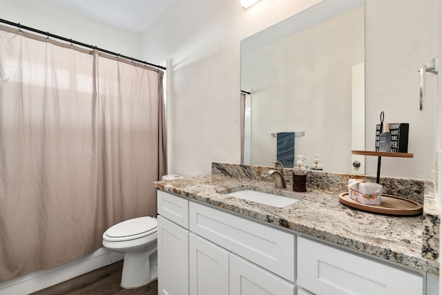 bathroom with a shower with curtain, vanity, toilet, and wood-type flooring