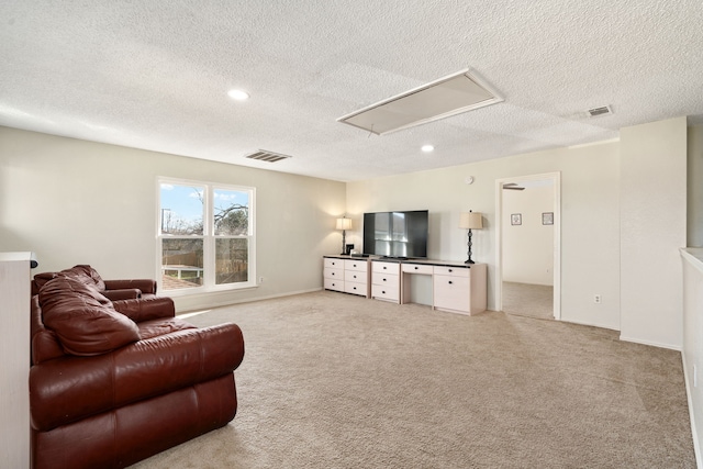 carpeted living room with a textured ceiling