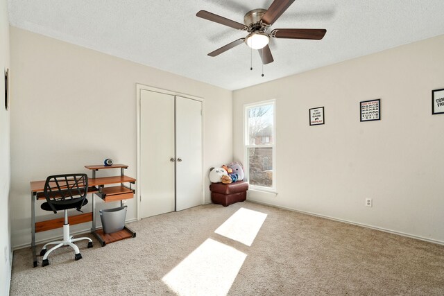 home office with ceiling fan, light colored carpet, and a textured ceiling