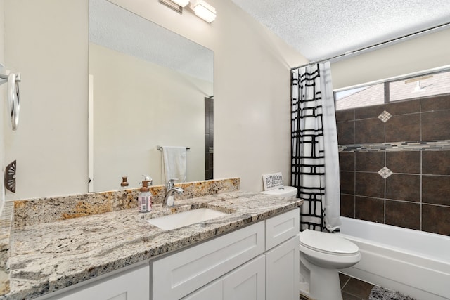 full bathroom featuring a textured ceiling, vanity, shower / tub combo with curtain, tile patterned flooring, and toilet