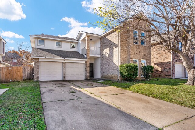 front of property with a balcony, a garage, and a front lawn