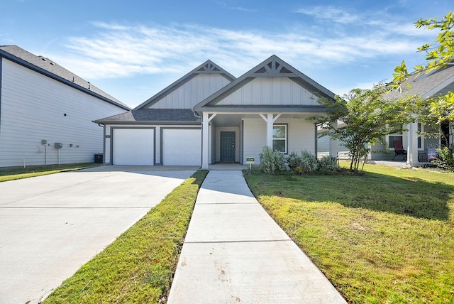 view of front facade with a porch, a garage, and a front yard