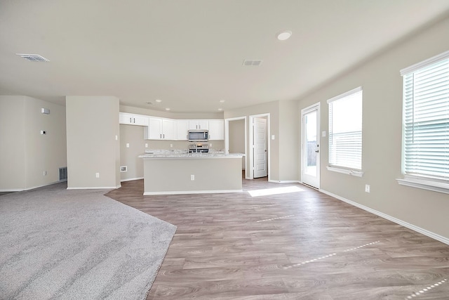 unfurnished living room with light hardwood / wood-style flooring