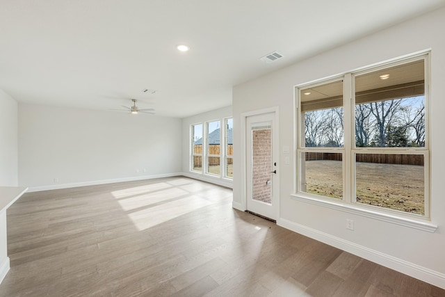 spare room with ceiling fan and light hardwood / wood-style floors