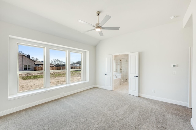 empty room featuring ceiling fan, light carpet, and lofted ceiling