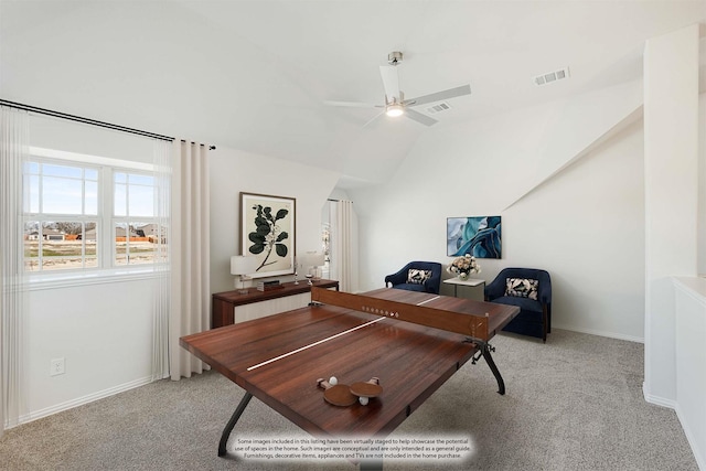 carpeted office space featuring vaulted ceiling and ceiling fan