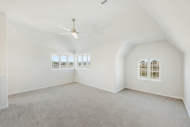 bonus room with ceiling fan, light carpet, and vaulted ceiling