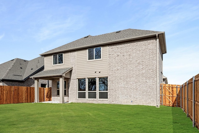 rear view of property with a lawn