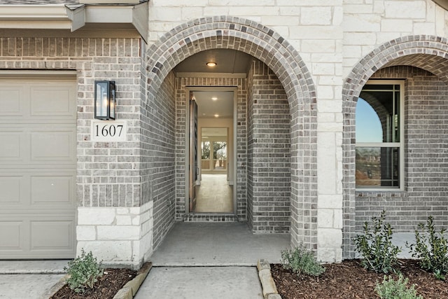 view of exterior entry featuring a garage