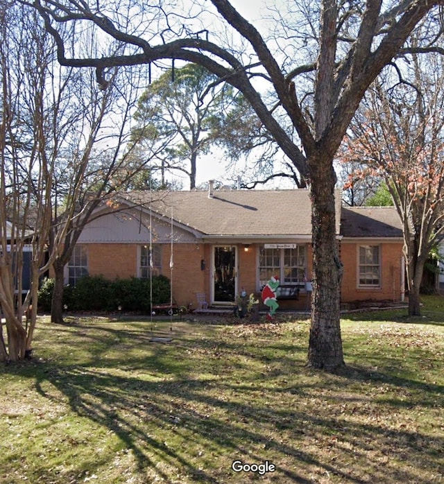 ranch-style home featuring a front yard