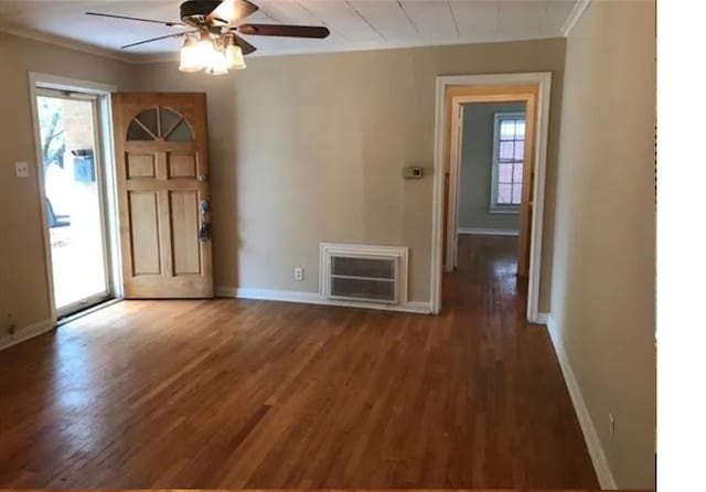 entrance foyer with ceiling fan, ornamental molding, dark hardwood / wood-style flooring, and heating unit