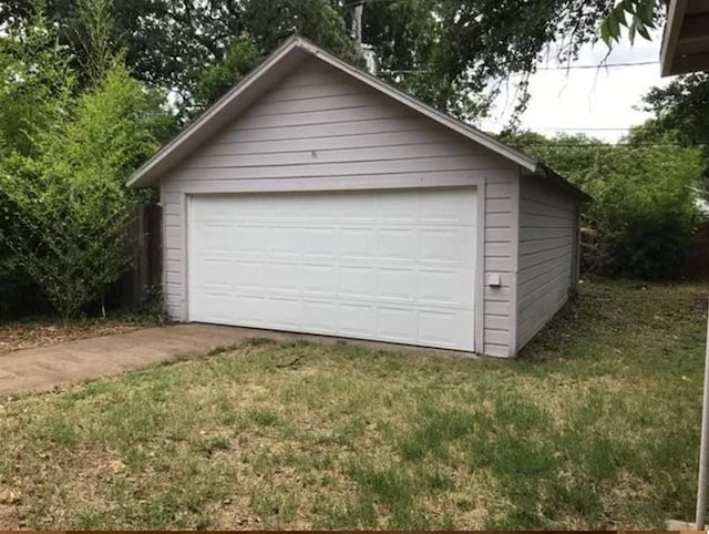 garage featuring a lawn