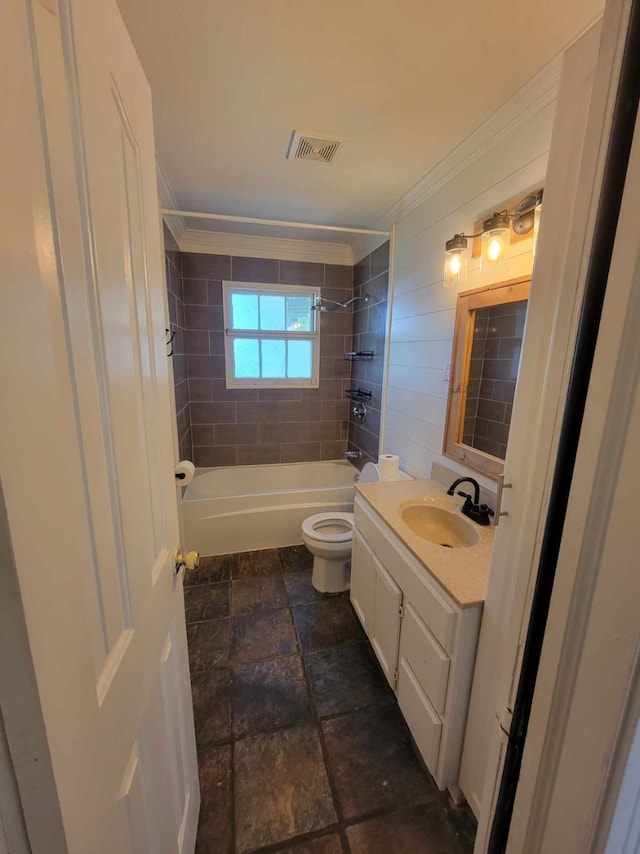 full bathroom with tiled shower / bath combo, vanity, toilet, and ornamental molding