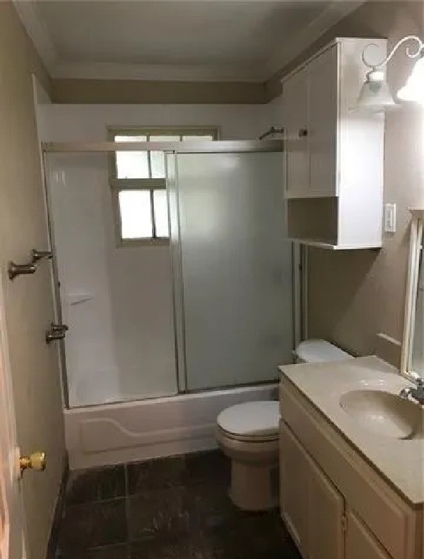 full bathroom featuring toilet, tile patterned flooring, shower / bath combination with glass door, vanity, and crown molding