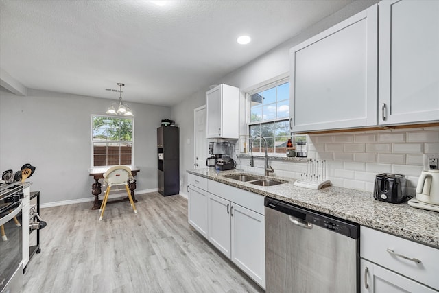 kitchen with light stone counters, stainless steel appliances, white cabinetry, sink, and tasteful backsplash