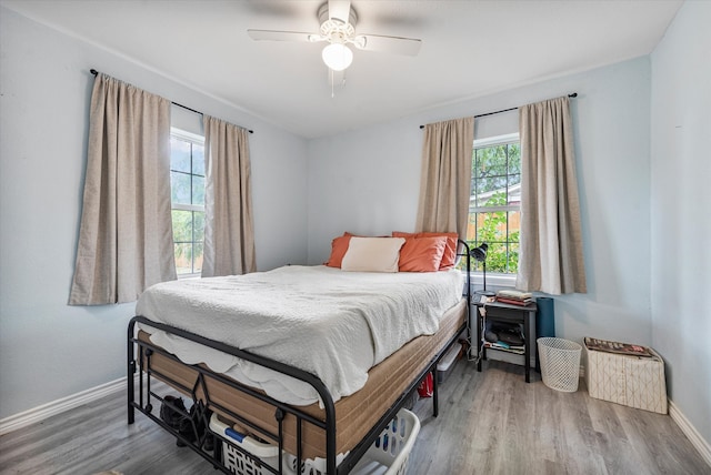 bedroom with wood-type flooring and ceiling fan