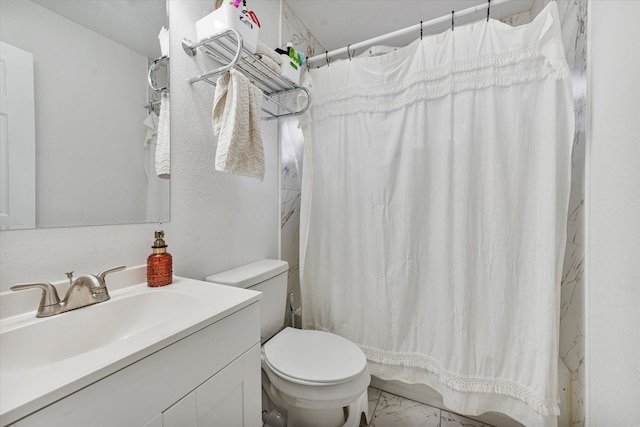 bathroom featuring vanity, toilet, and curtained shower