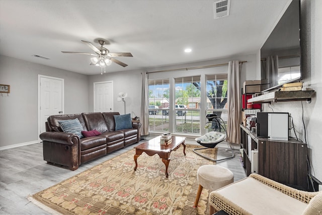 living room with ceiling fan and light hardwood / wood-style floors