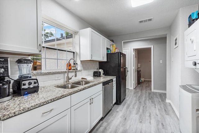 kitchen with stainless steel dishwasher, sink, and white cabinets