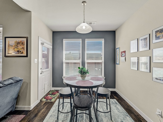 dining space with dark wood-type flooring