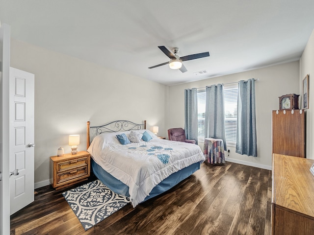 bedroom with dark hardwood / wood-style floors and ceiling fan