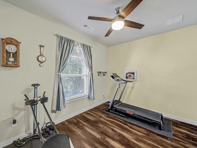 exercise area with dark wood-type flooring and ceiling fan