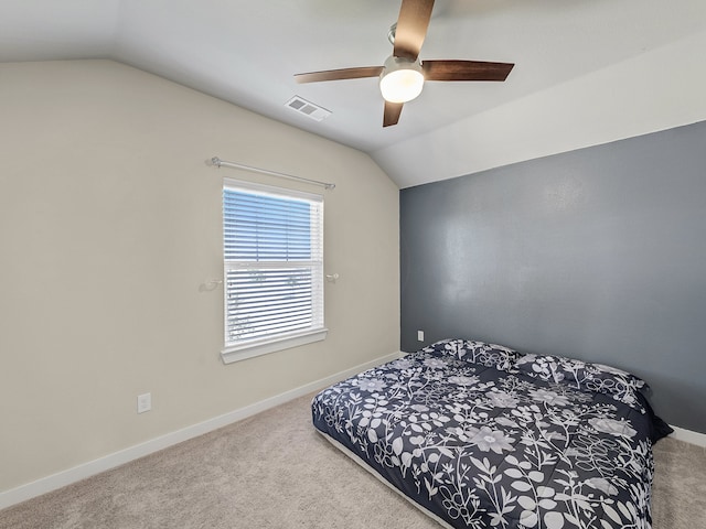 carpeted bedroom featuring ceiling fan and vaulted ceiling