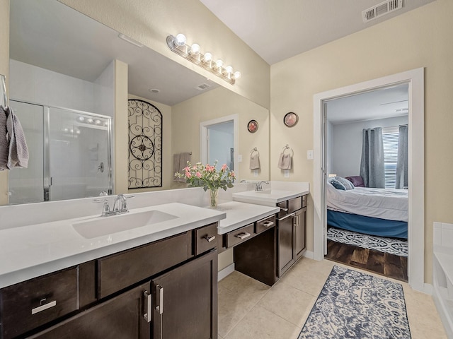 full bath with a stall shower, visible vents, connected bathroom, tile patterned floors, and vanity