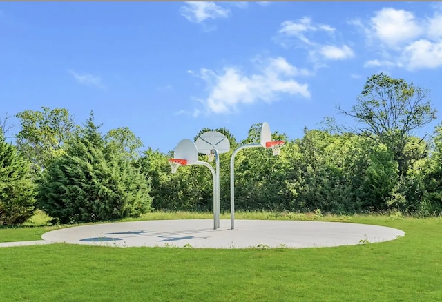 view of sport court with a yard