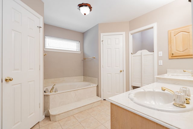 bathroom featuring vanity, a bath, and tile patterned floors