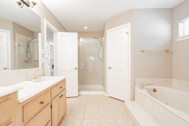 bathroom with tile patterned floors, independent shower and bath, and vanity